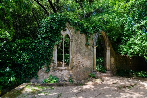 A beautiful shot of a remnant of an ancient building surrounded by trees from Quinta Das Lagrimas, Coimbra, Portugal