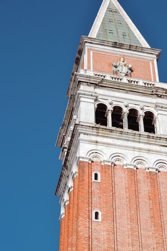 A low angle of an old historical
St Mark's Campanile located in Italy