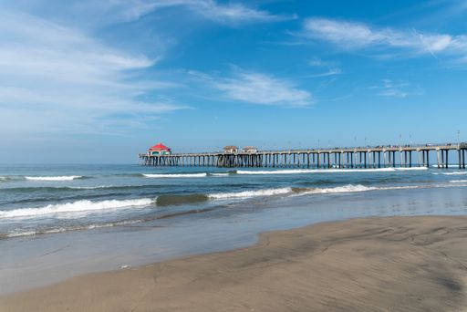 A beautiful shot of a calm empty beach with small houses on the dock