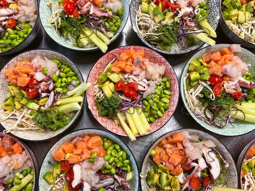 several poke bowl salad made with rice vegetables and raw fish