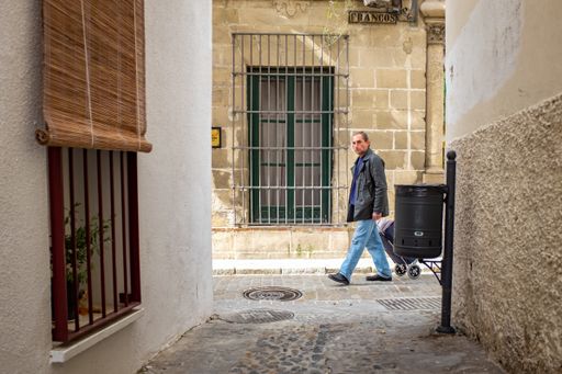Jerez de la Frontera, Cadiz / Spain - April 4 2015: Man Walking in Old Colonial Street Looking at the Camera