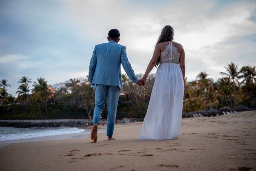 A closeup shot of a couple enjoying their walk on the beach at daytime