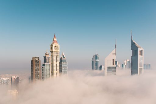 A beautiful view of the high residential buildings covered in the clouds in Dubai