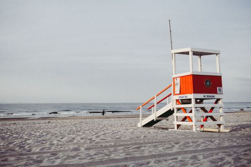 A red rescue cabin on a sandy beach