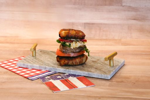 A juicy bacon wrapped bun steak burger