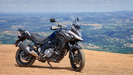 cruiser motorcycle on mountain with village background