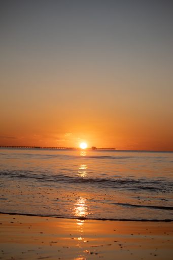 A vertical shot of the sunset over the sea