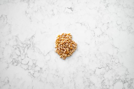 Ingredient show top down. Pine seeds, commonly used in pesto, salads and pasta