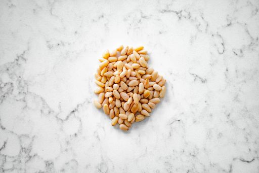 Ingredient show top down. Pine seeds, commonly used in pesto, salads and pasta