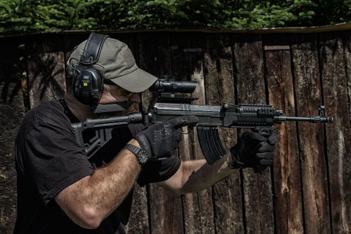 A man shooter at the shooting range training with gun