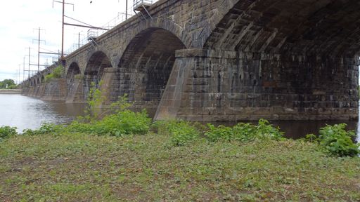 bridge used as train tracks to cross over a body of water