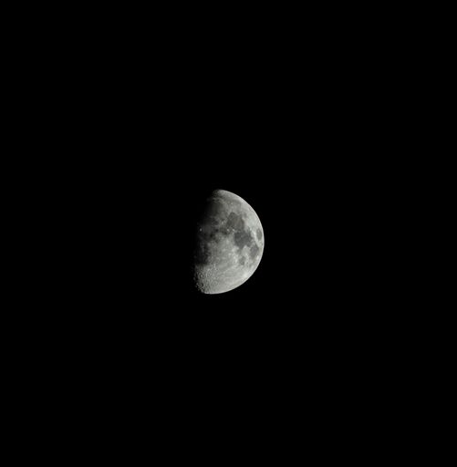 A beautiful grayscale shot of moon in the sky