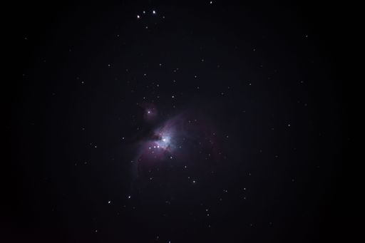 a long exposure of Orion Nebula with many stars in the sky