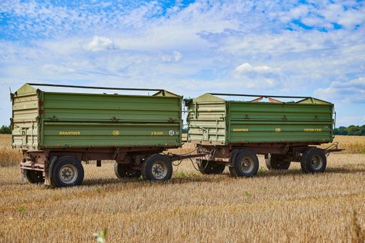Berlin, Germany - July 28, 2020: Two trailers on a harvested field in the surrounding countryside of Berlin, Germany.