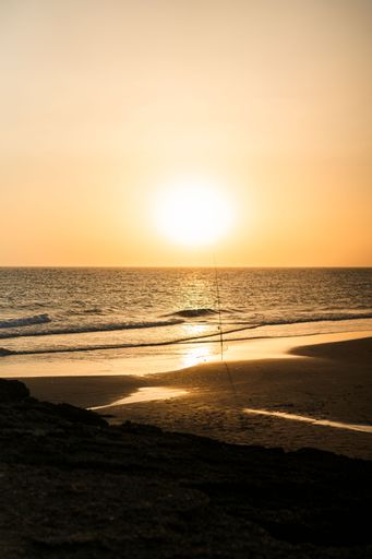 A beautiful shot of a golden sunset over a calm tranquil sea