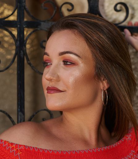 A closeup shot of a beautiful brunette woman in a red outfit