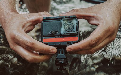 A closeup of a man holding a GoPro camera