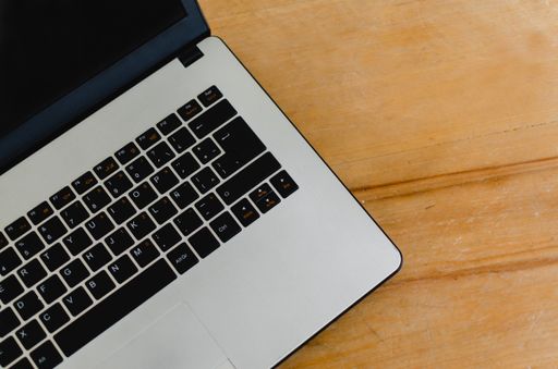 A high angle closeup shot of a laptop on a wooden table