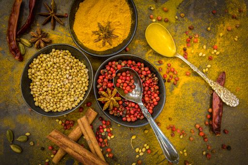 A top view of healthy berries and spices in bowls