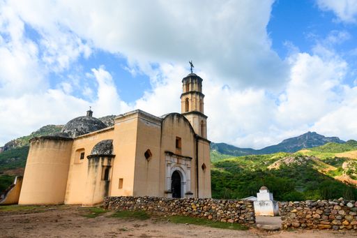 A beautiful shot of a temple in the middle of a mountainous scenery under the cloudy sky