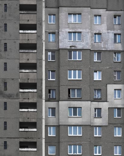 A vertical shot of a concrete apartment building - great for a cool background