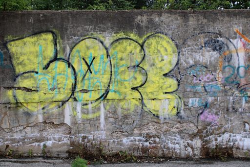 A Graffitied wall with the tag 5033 in yellow color