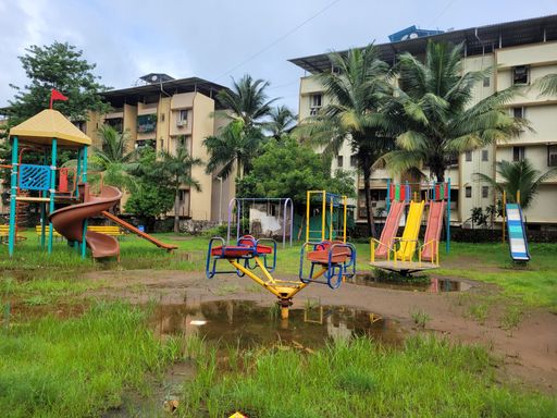 Wide shot of an empty playground in the park after a rain in Mumbai