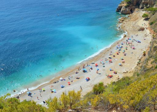 An aerial shot of crowded sandy beach