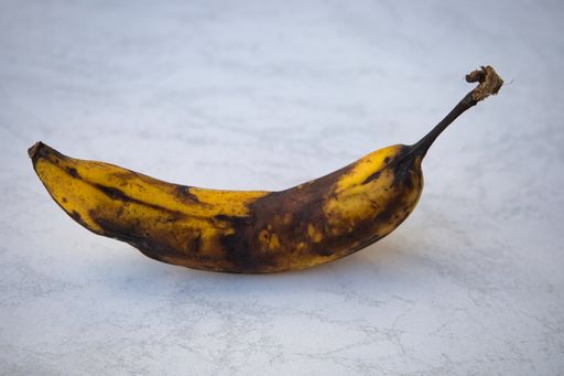 A closeup shot of an overripe banana on a bright background