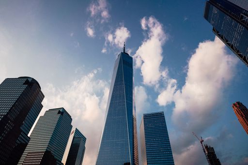 A low-angle shot of the famous One World Trade Center skyscraper in New York, USA under blue sky