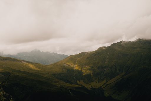 Picturesque mountain landscape. Beautiful view of the mountain range covered with greenery under cloudy sky
