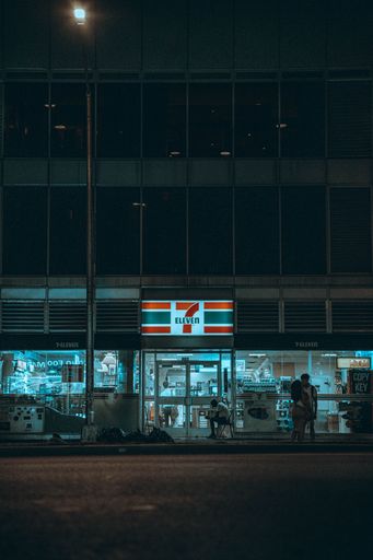 A 7Eleven shop front in the street in New York City at night
