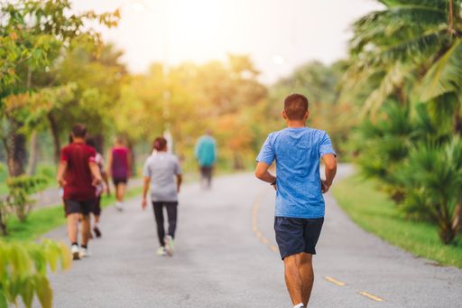 A closeup of people running in the city park