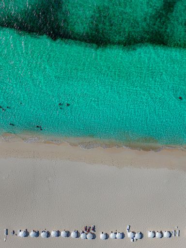 An aerial view of a beach with people resting