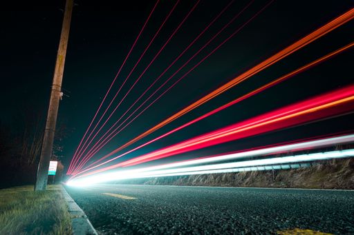 A low angle of traffic lights at night shot in long exposure