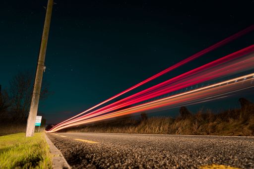 A low angle of traffic lights at night shot in long exposure