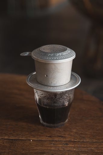 A vertical shot of Vietnamese coffee on a wooden surface