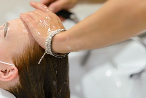 A closeup shot of a young female getting her hair washed in a hair salon