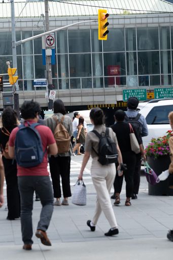 A vertical shot of pedestrians near Union Station waiting to cross the street on York Street