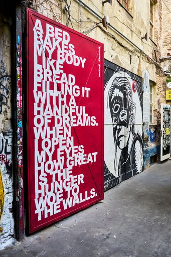 A vertical shot of beautiful graffiti art in Hackescher Markt street,  Berlin