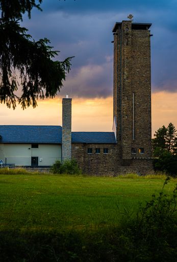 A scenic view of a tower against an stormy evening sky