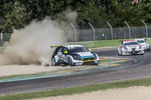 An auto racing scene with three sports cars smashing the sand in an autodrome