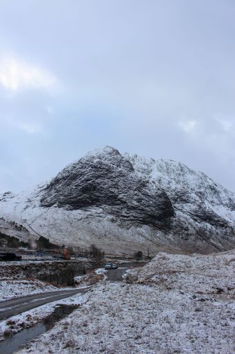 A vertical shot of the road to Glen Etive in winter, snow covered mountain landscape in Glencoe Scotland