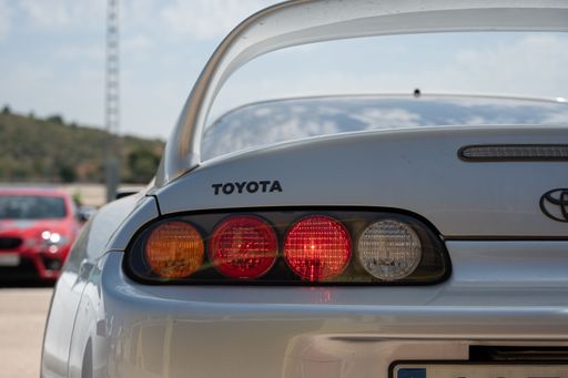 The rear view of a white Toyota Supra sports car