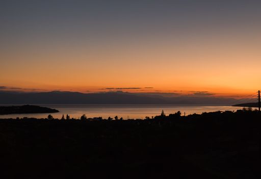A silhouettic view of a beach during sunset