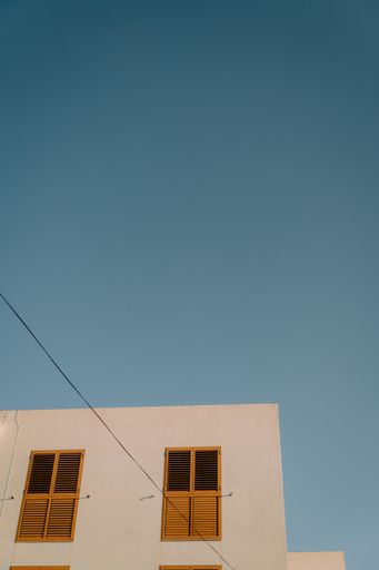 A low-angle shot of the hotel building in Ibiza island against a blue sky