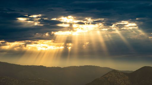 The beautiful view of sunbeams penetrating through the clouds.