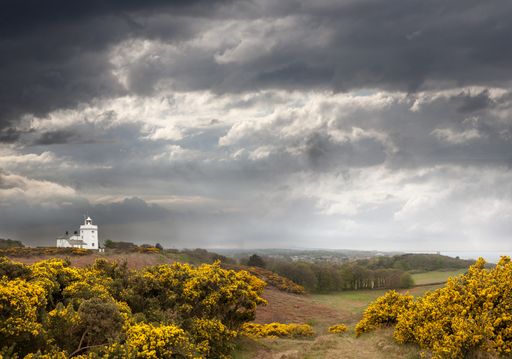 A high angle shot of the Cromer Lighthouse in North Norfolk of the United Kingdom under the grey cloudy sky