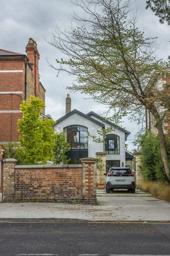A vertical view of the vehicle parked by a residential street-side building on a cloudy day in Dublin
