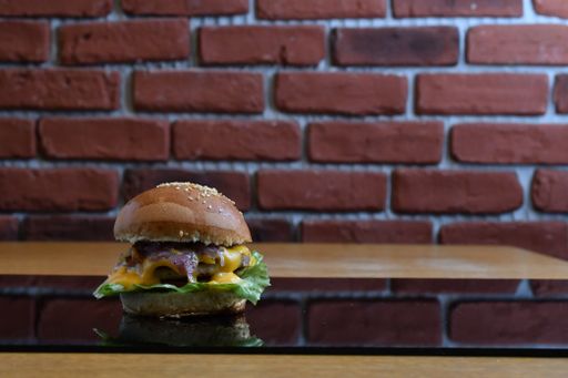A closeup shot of delicious hamburgers against a brick wall